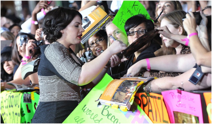 Stephenie Meyer signs autographs for a crushing crowd of fans.