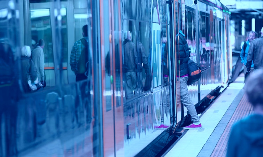 people getting on a train in Auckland