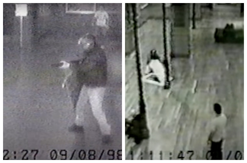 Blurry black and white security footage showing a man with a gun, and later tearing a painting out of its frame.