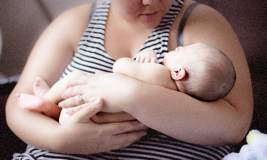 A mum holding her baby.