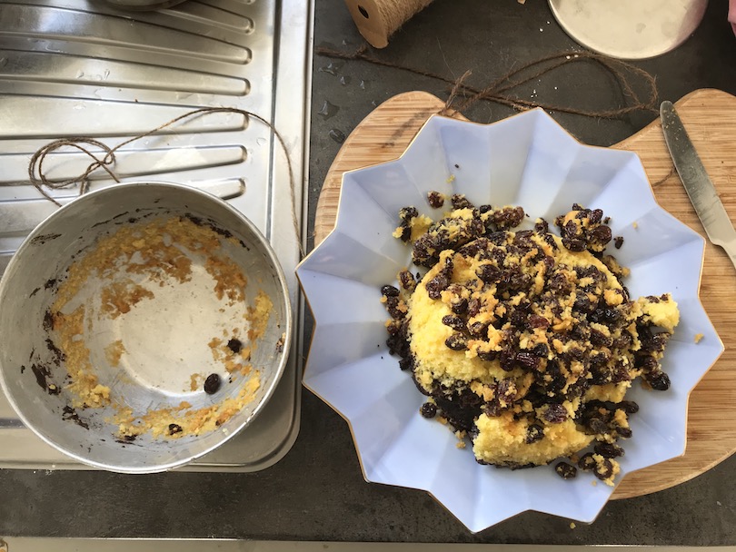 A collapsed steamed pudding, raisins all over the place.